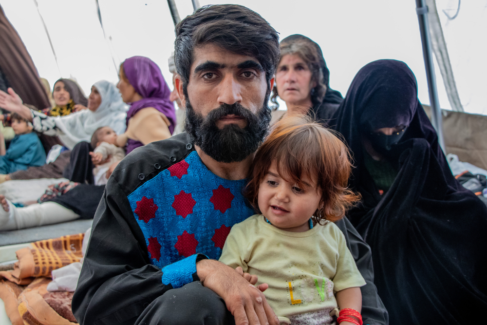 Hassan Mirzaie and his daughter inside one of the MSF tents at the Herat Regional Hospital where victims of the earthquake are receiving treatment. Afghanistan, 2023. © Paul Odongo/MSF