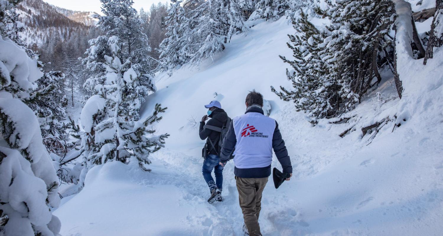 MSF staff walk part of the snow-covered trail in the mountains northwest of Turin, used by people seeking to cross from Italy to France