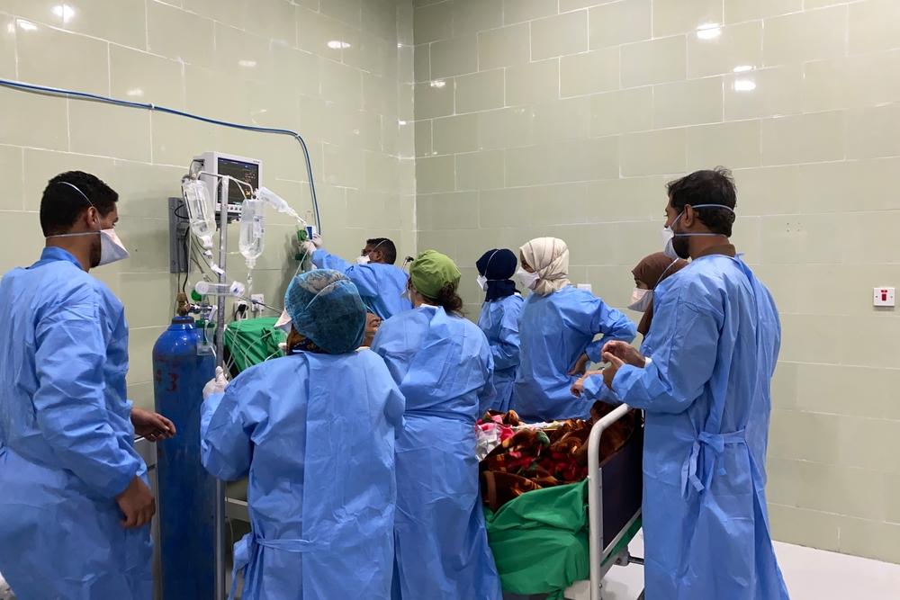 Staff work to treat a COVID-19 patient in Aden's Al Gamhouria hospital