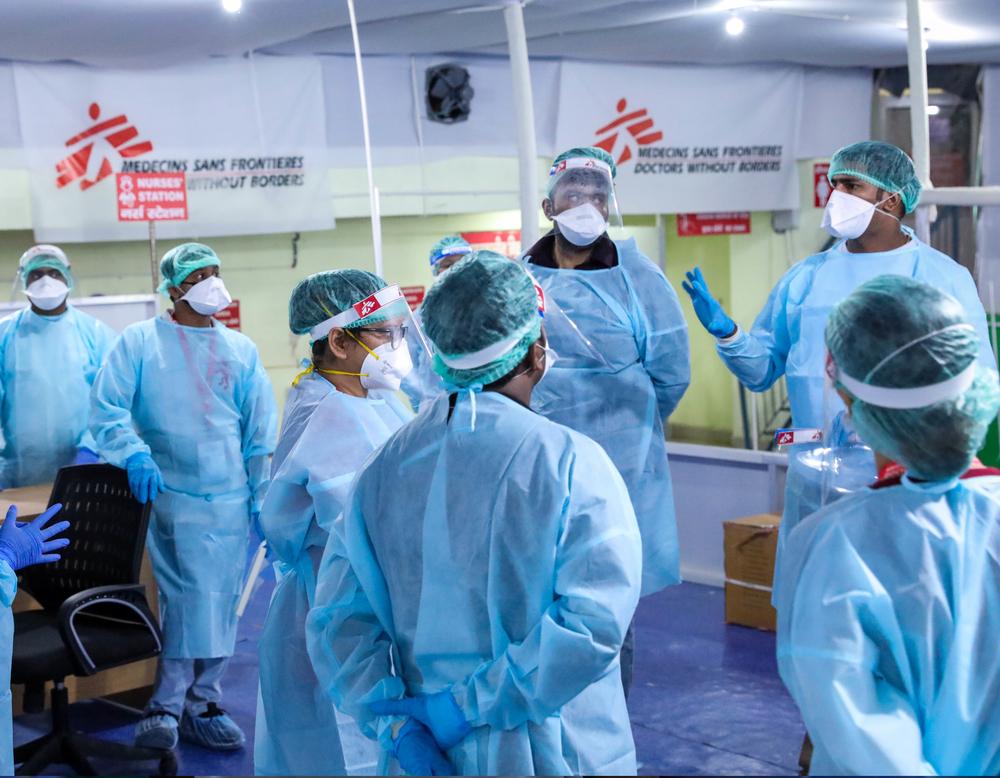 Representatives from different teams carefully check the PPEs and protocols. © Aahana Dhar/MSF
