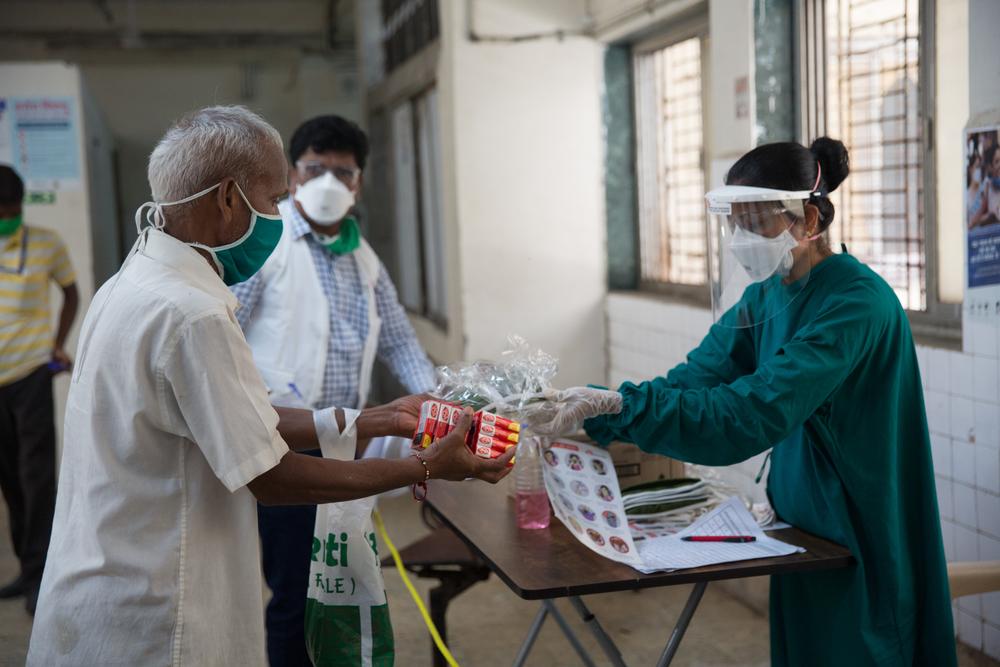 MSF nurse distributing masks and soaps in hospitals.