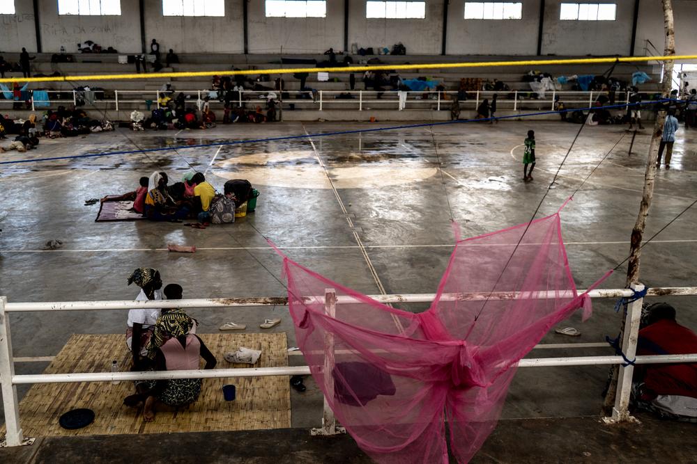 People sit inside a stadium which has been converted to a reception centre for internally displaced people fleeing the armed conflict which has been taking place in Mozambique's Cabo Delgado province. © Tadeu Andre/MSF
