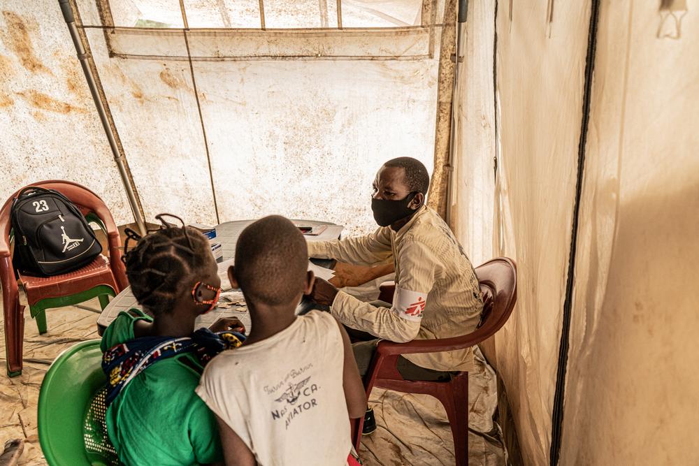 Patients are seen inside a mobile clinic set up and operated by Doctors Without Borders in Nicuapa, a camp for internally displaced people who have fled fighting in parts of Mozambique's Cabo Delgado province. As a result of the conflict large numbers of people requiring medical attention have been unable to reach it in these camps and surrounding cities like Pemba and Montepuez. © Tadeu Andre/MSF