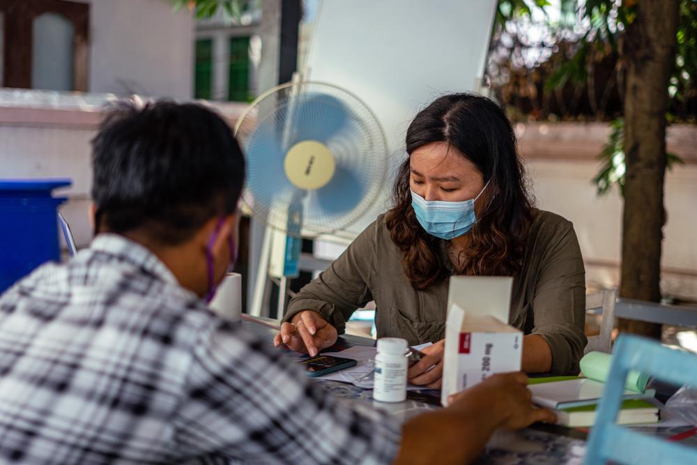 staff member prepares medication for a patient