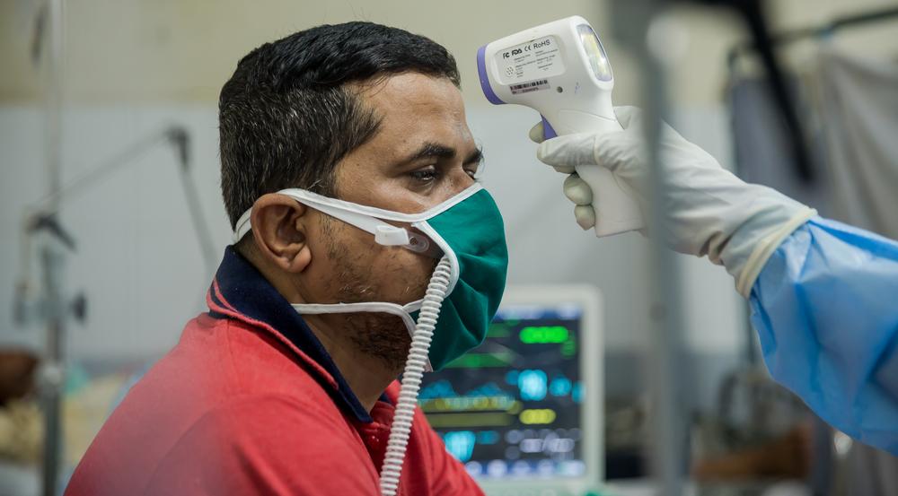 Checking patient's temperature. Mumbai, India.