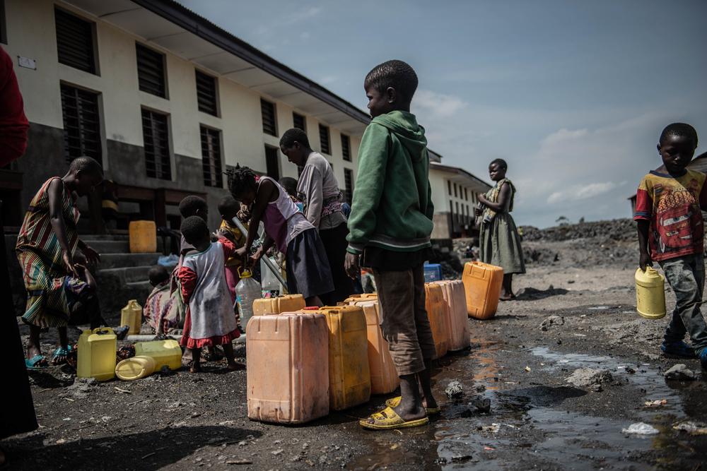 Children fetch water in a water point built by Doctors Without Borders.