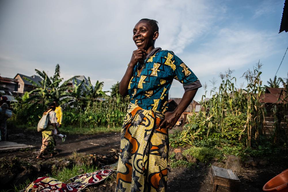 Faida Lumo in front of her house in Sake. The town sheltered about 180,000 people displaced from Goma after the eruption of Mount Nyiragongo.