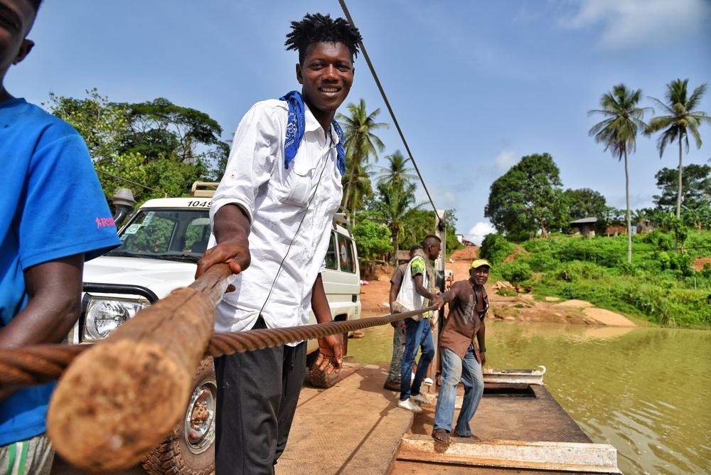 Ferry worker transports Doctors Without Borders vehicle across Sewa river in Kenema district, eastern Sierra Leone. 