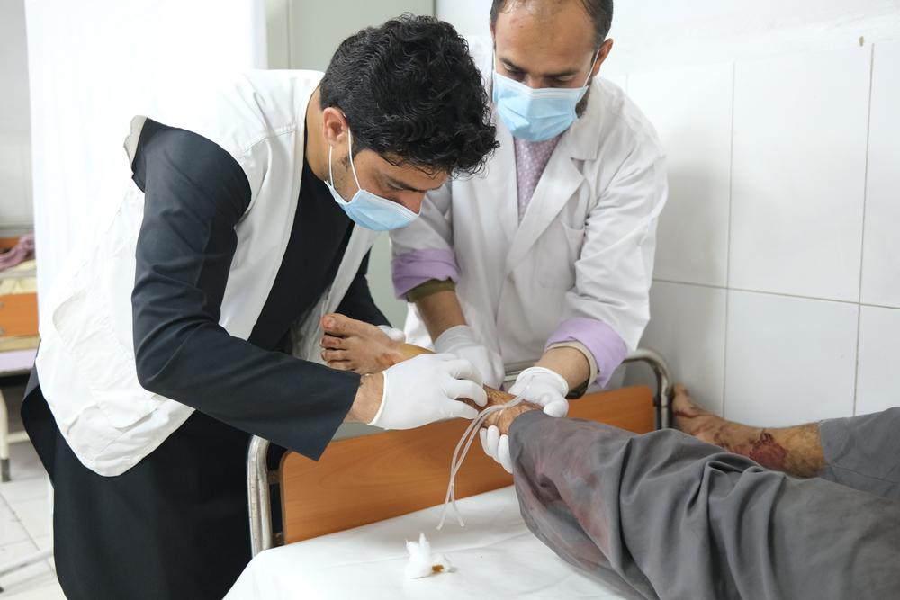 MSF Emergency room supervisor Masood Khan treats a patient for a gunshot wound at the Boost hospital. Helmand province, Afghanistan 