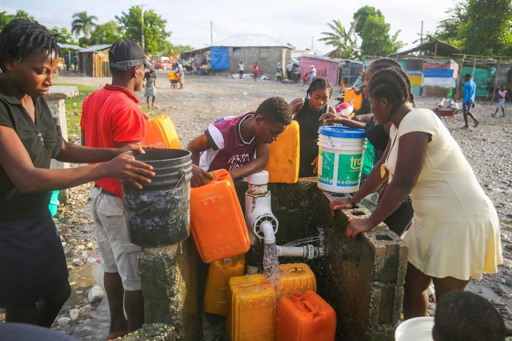 People gathering water at one of the water points at Croix Marti, an area of Les Cayes city.