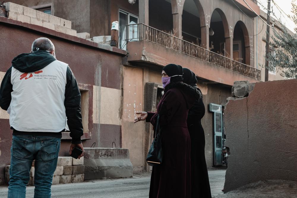 In the street in front of the MSF's clinic in Arsal, a staff speaks with two patients. Lebanon. © Karine Pierre/Hans Lucas for MSF 