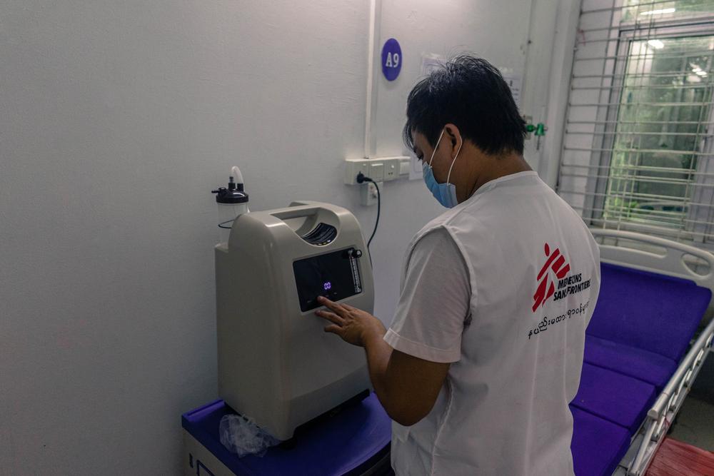 MSF medical doctor sets up an oxygen concentrator in the MSF COVID-19 ward in Yangon’s Aung San Tuberculosis Hospital on 26 July 2021 as the facility prepares to open to treat patients affected by Myanmar’s third wave of the pandemic.