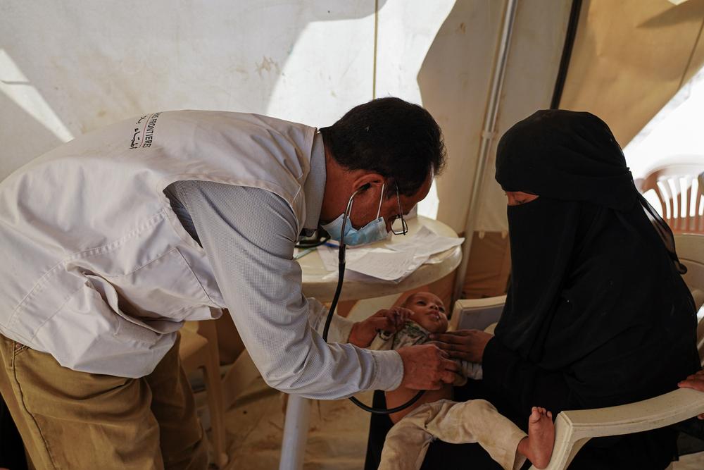 MSF doctor examining one-year-old Mahsan at the Al-Hussun mobile clinic in Marib, Yemen.