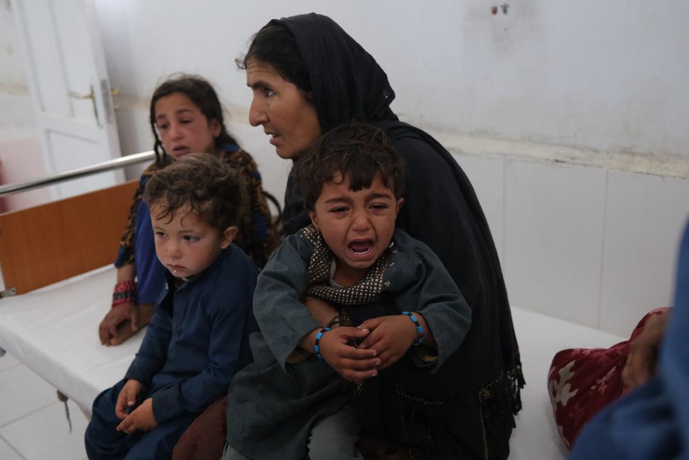 Han Bibi with her grandchildren in the measles screening unit at Boost hospital. 