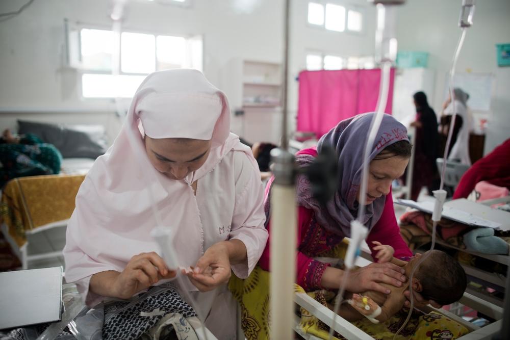 A newborn is examined by Pediatric Nurse Isabelle Arnould and midwives in the neonatal ward of the MSF Maternity Hospital in Khost, Afghanistan.