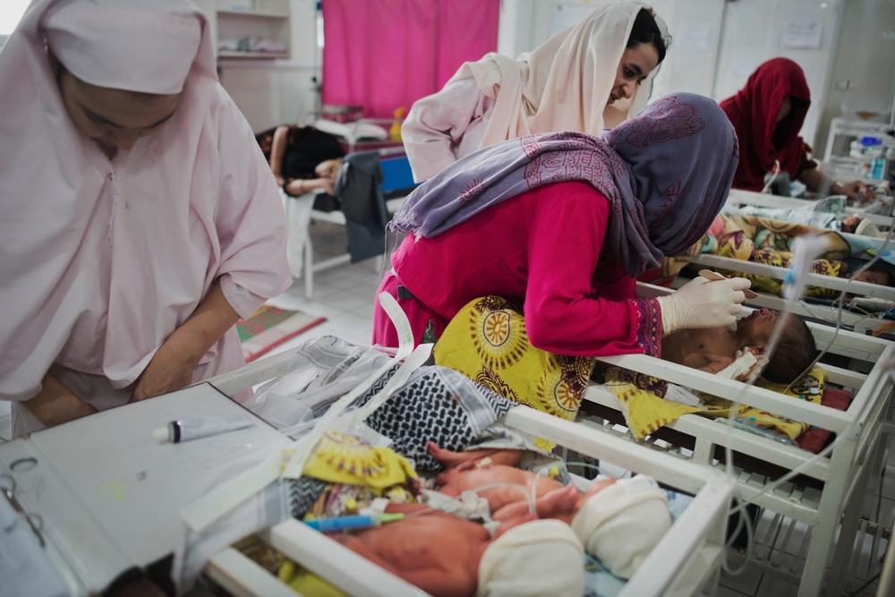 A newborn is examined by Pediatric Nurse Isabelle Arnould and midwives in the neonatal ward of the MSF Maternity Hospital in Khost, Afghanistan.
