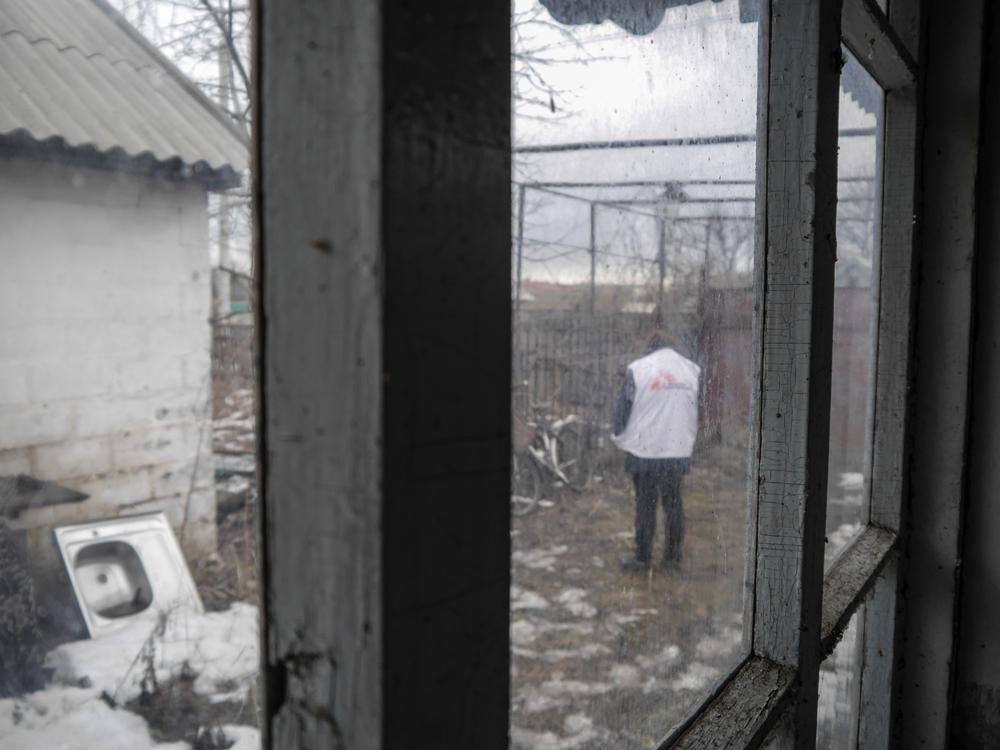 A Doctors Without Borders staff stands outside the abandoned house where Doctors Without Borders operates a mobile clinic in the village of Vodiane. 