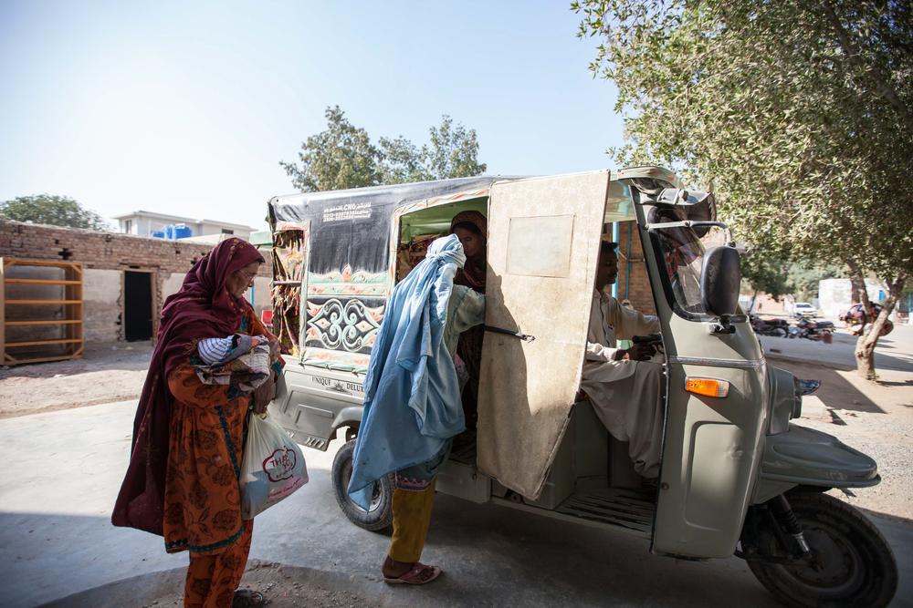 Gulshan, in blue, gets into a waiting rickshaw that her 22-year-old son has hired to take her, his grandmother, aunt and newborn sister home once Gulshan has been discharged from hospital.