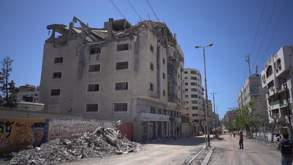 Palestinian walks amidst the rubble in the Gaza city.