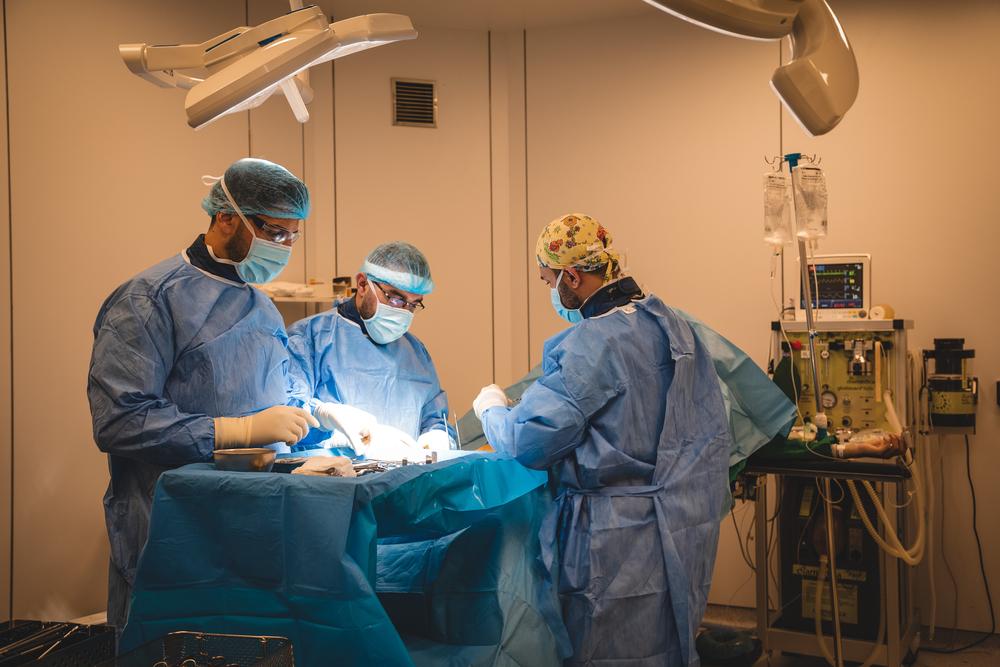 MSF surgical team conducts an external fixation placement surgery for a patient