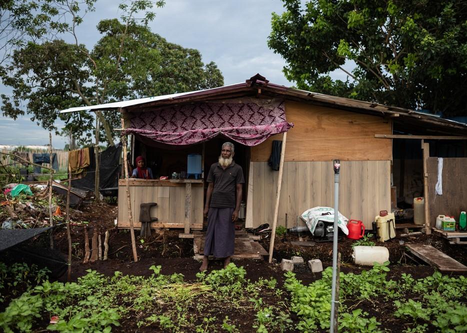 Mohamed T., 56 years old, stands in front of the small shelter.