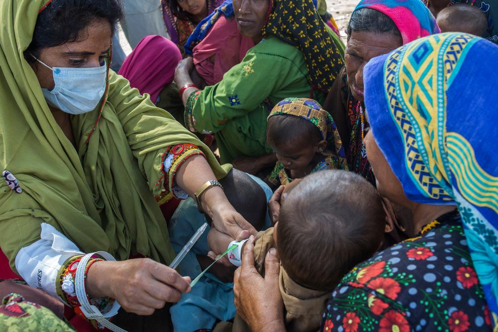 an MSF staff examines temperature and assessment of a malnutrition child during a mobile clinic setup in the Ghulam Muhammad Lashari village of Thul town of Jacobabad District in the Sindh Province of Pakistan