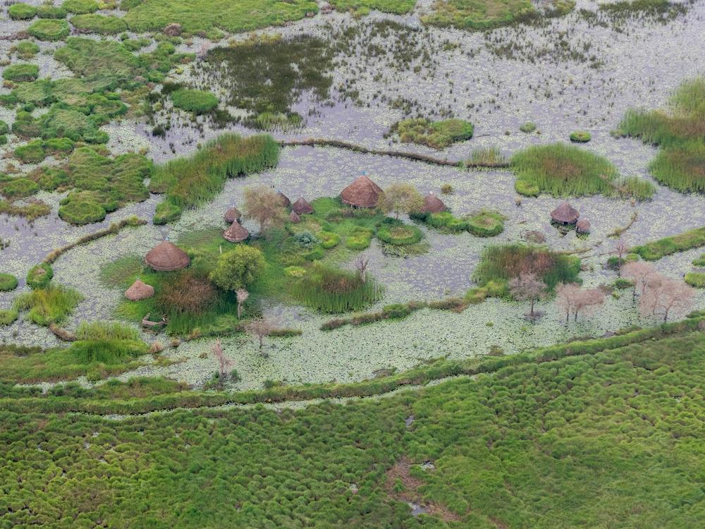Aerial view of a flooded village near Old Fangak, South Sudan. The fourth year of consecutive flooding has devastated the area. South Sudan, 2022. © Florence Miettaux