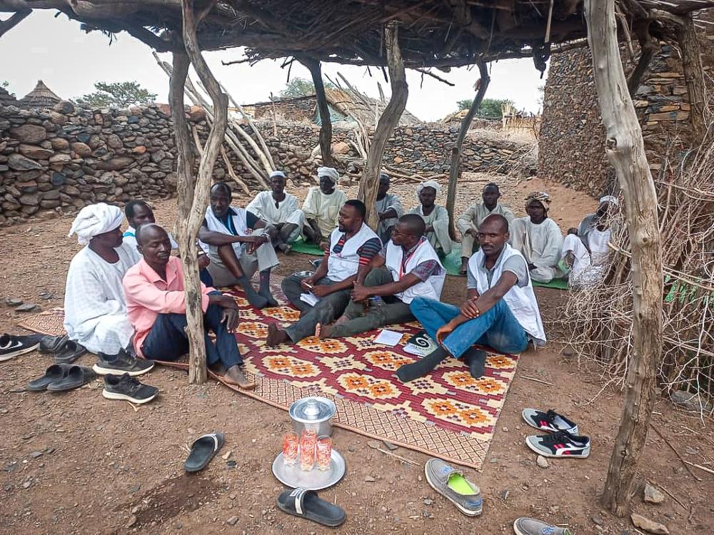 MSF community engagement PC Nkemju Rosevelt and team, meeting with elders/leaders in village in Jebel Marra. Sudan, March 2023. © MSF