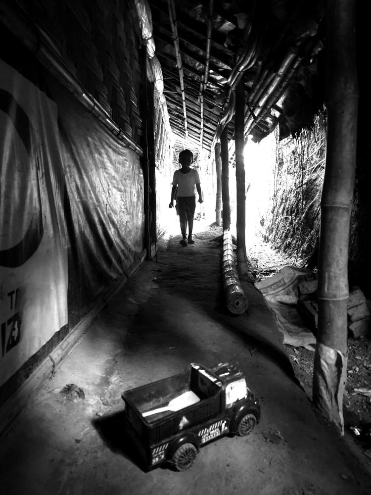 A Rohingya child and his toy in the alley of a makeshift in Rohingya refugee camp in Bangladesh.