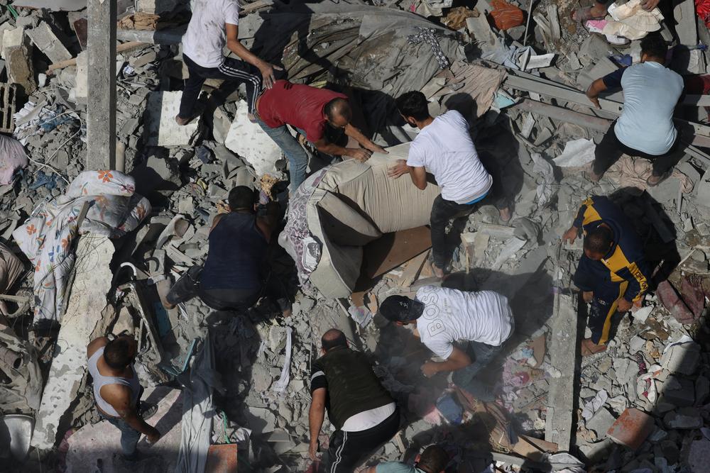 Residents search for survivors in the destruction caused by airstrikes in Gaza. Palestinian Territories, October 2023. © Mohammed ABED