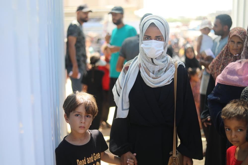 A Palestinian mother holds her son hand in Khan Younis, Gaza Strip.