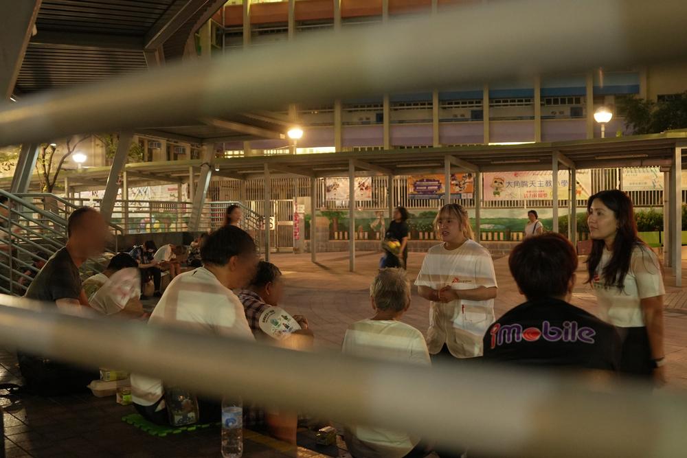 Doctors Without Borders staff interact with community members during a group activity in Hong Kong