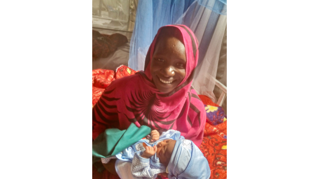 A mother and her newborn at the maternity ward of Aboutengué camp.