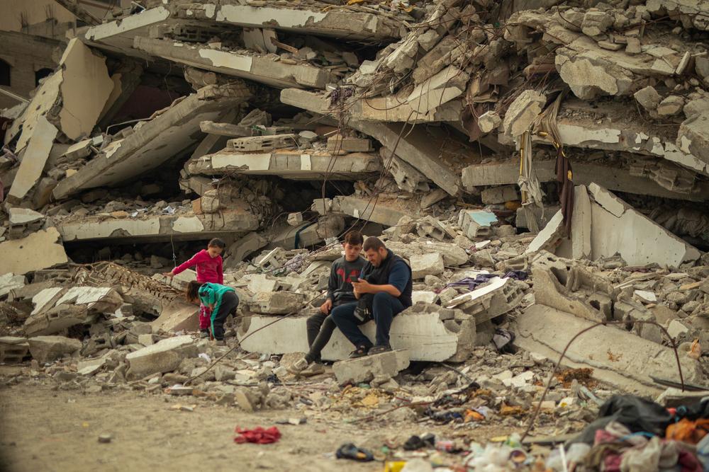 At Al Saraya in Gaza City, people are sitting on the rubble of their destroyed home, with their tent set up across from the debris.
