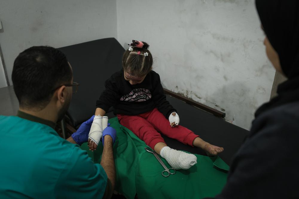 MSF nurse is tending to a child patient's dressings at the clinic in Gaza City.