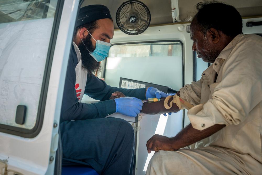 an MSF nurse, collects a blood sample from a patient during an outreach activity in a neighbourhood of Machar Colony in Karachi, Pakistan