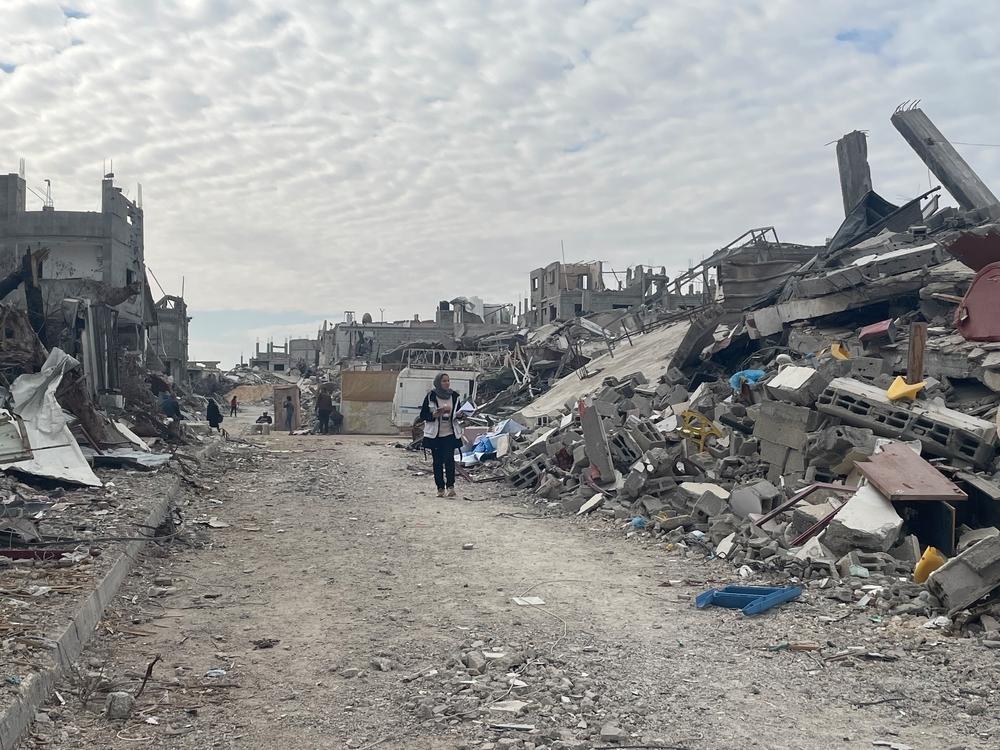 A woman walking through the ruins of Rafah city, southern Gaza.