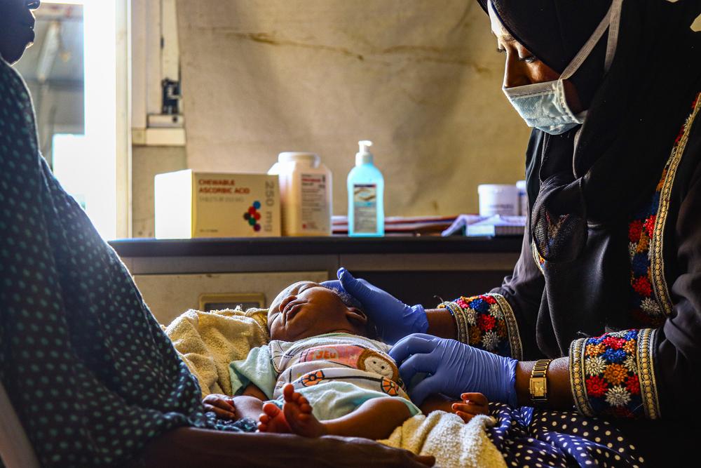 A doctor examining a patient at the Kalma camp health centre which run by MSF.