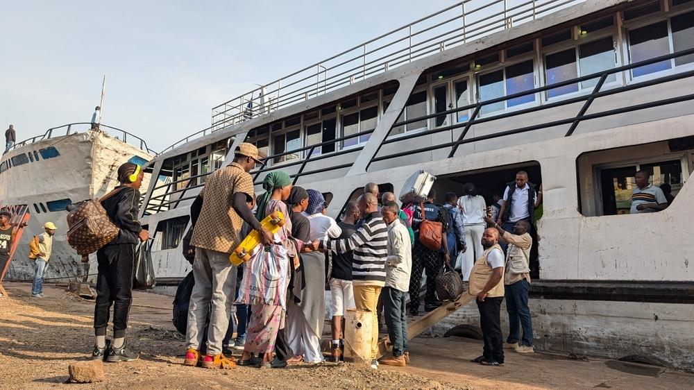 People get on board on a ship at the port of Bukavu, DRC