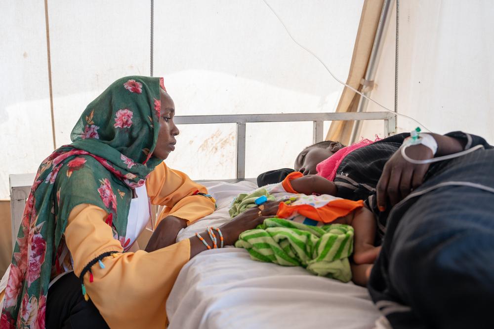 Health promoter Aisha B. is comforting a mother who was diagnosed with Malaria and needs support with her 5 months old baby