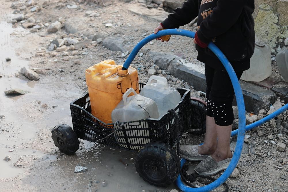 Palestinian child is collecting water in Beit Lahia city, north of Gaza strip