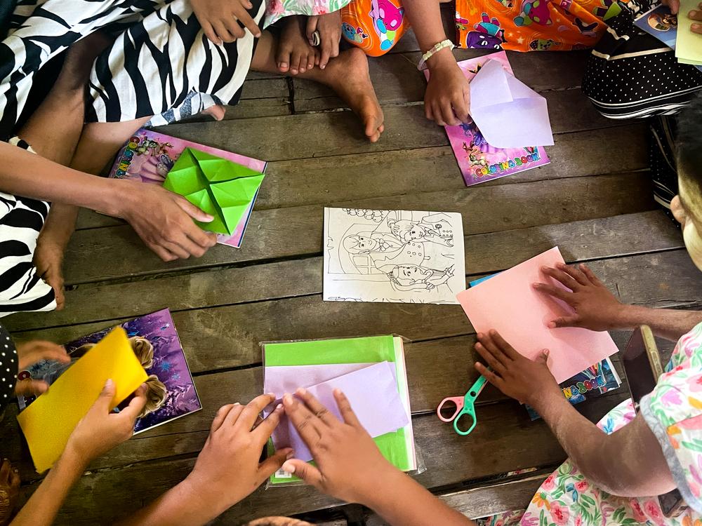 Children playing with craft paper